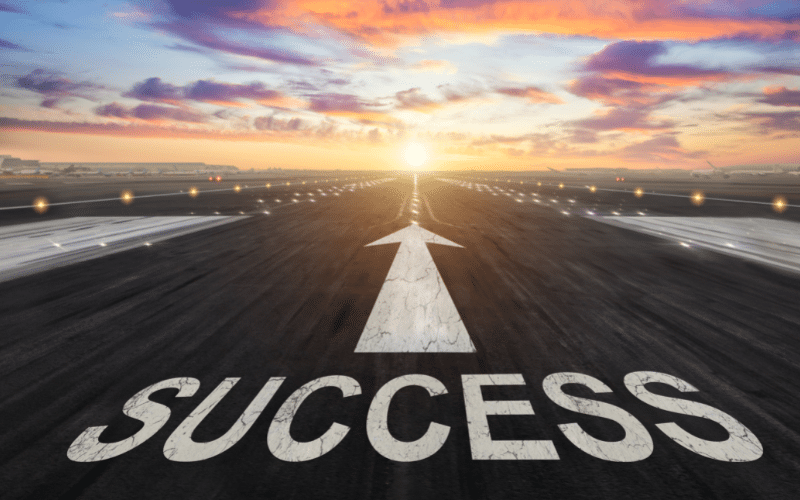 Runway with 'SUCCESS' written on it leading into the sunrise, symbolizing the journey to recovery at Key Healthcare